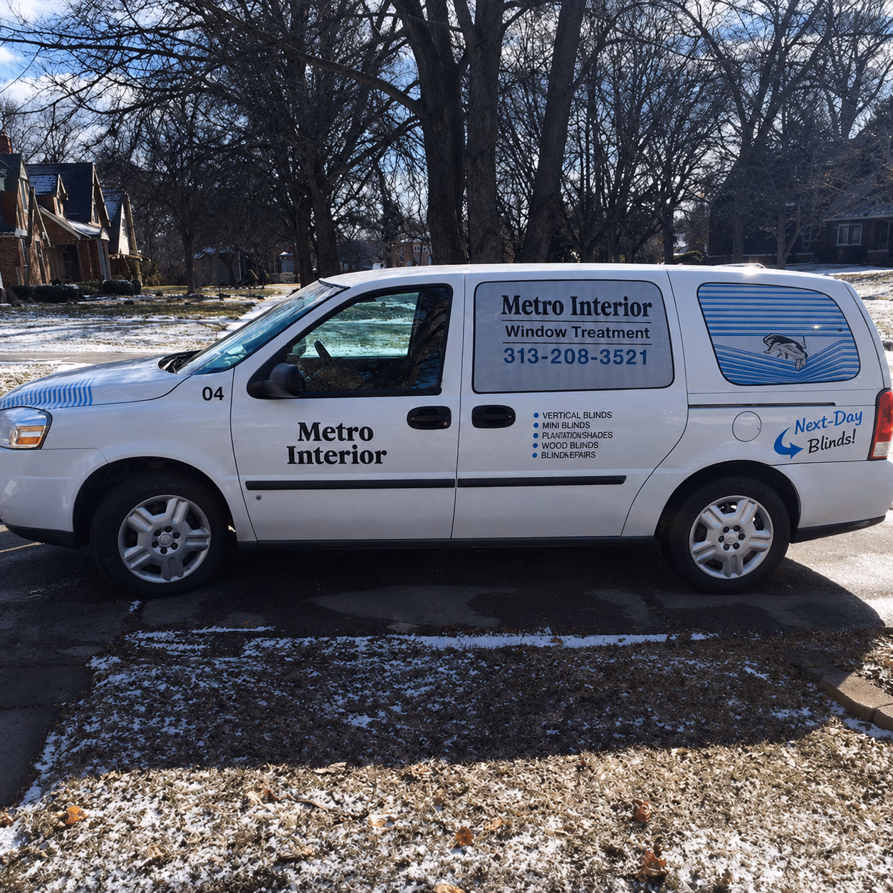 White Metro Interior company van with window treatment ads and phone number 313-208-3521 on side.